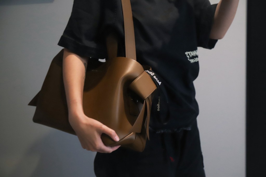 Acne Studios Musubi Tote - Camel Brown - Holding - Using Shoulder Strap - On Woman's Body